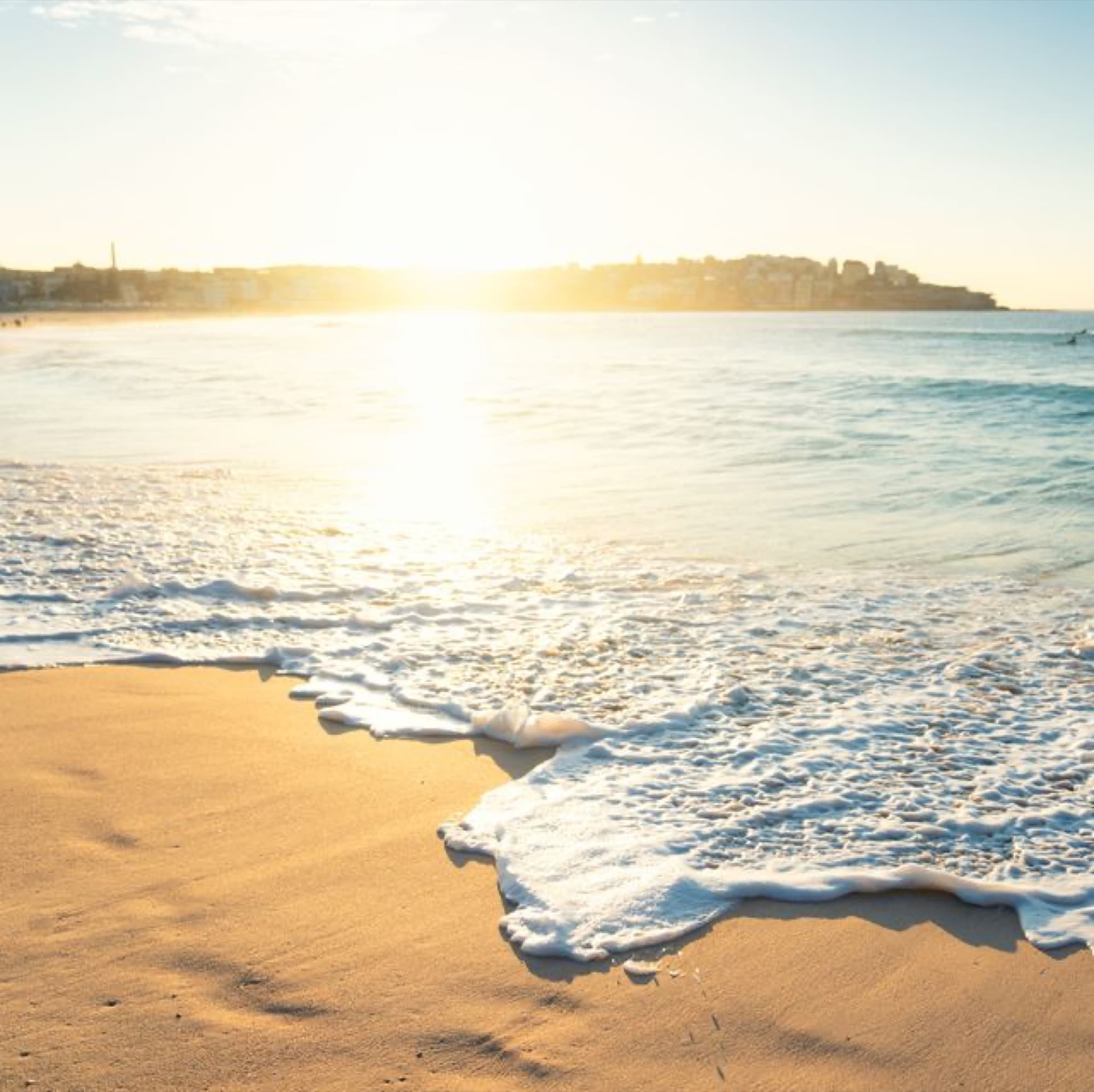 Waves rolling onto the beach at sunrise